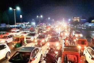 Heavy traffic jam on SG Highway Ahmedabad due to AMC road construction work causing long vehicle queues and commuter delays.